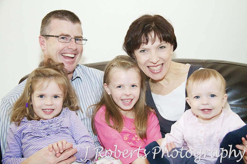 Family of 5 laughing on the couch - family portrait photography sydney